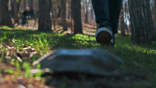 Video - Man in medical gloves picking up dirty medical masks from the ground in a park. Pollution idea