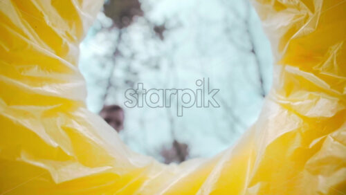 Video - Man throwing a medical mask into a trash can. View from inside the can. Slow motion