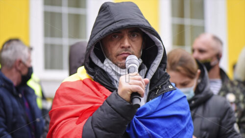 Video - CHISINAU, MOLDOVA - APRIL 28, 2021: Man talking in the microphone. People protesting for snap elections in front of constitutional court building. Slow motion