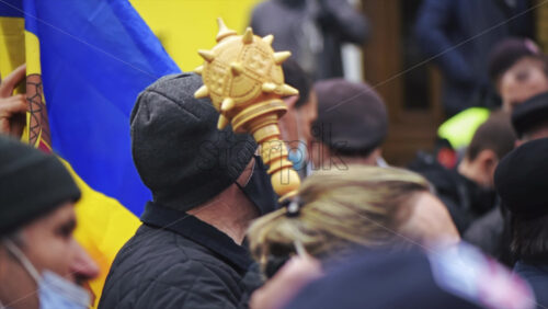 Video - CHISINAU, MOLDOVA - APRIL 28, 2021: Man with flag and wooden mace. People protesting for snap elections in front of constitutional court building. Slow motion