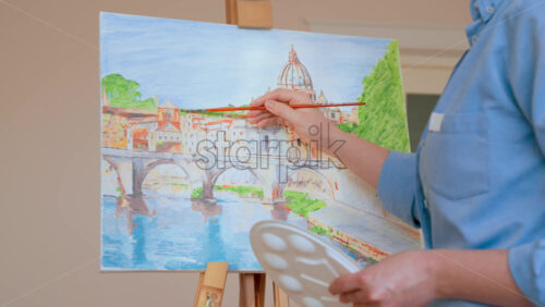 Video - Caucasian woman painting a picture with a palette in her hands, indoors
