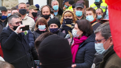 Video - CHISINAU, MOLDOVA - APRIL 28, 2021: Woman talking in the microphone. People protesting for snap elections in front of constitutional court building