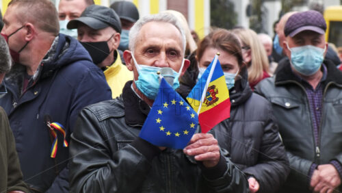 Video - CHISINAU, MOLDOVA - APRIL 28, 2021: Man with EU and national flag talking in the microphone. People protesting for snap elections in front of constitutional court building