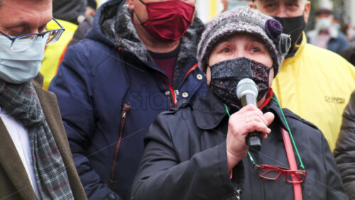 Video - CHISINAU, MOLDOVA - APRIL 28, 2021: Woman talking in the microphone. People protesting for snap elections in front of constitutional court building
