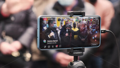 Video - CHISINAU, MOLDOVA - APRIL 28, 2021: Shooting of a group of talking people on smartphone. People protesting for snap elections in front of constitutional court building