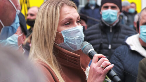 Video - CHISINAU, MOLDOVA - APRIL 28, 2021: Woman talking in the microphone. People protesting for snap elections in front of constitutional court building
