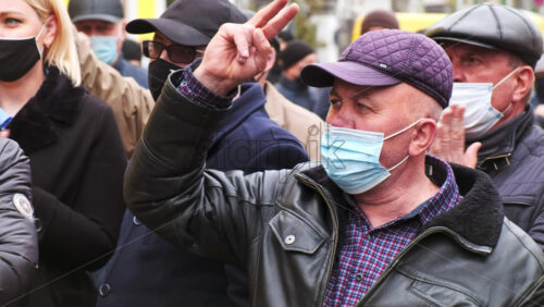 Video - CHISINAU, MOLDOVA - APRIL 28, 2021: Shouting group of people. People protesting for snap elections in front of constitutional court building