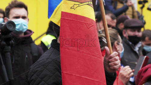 Video - CHISINAU, MOLDOVA - APRIL 28, 2021: Man with flag and wooden mace. People protesting for snap elections in front of constitutional court building