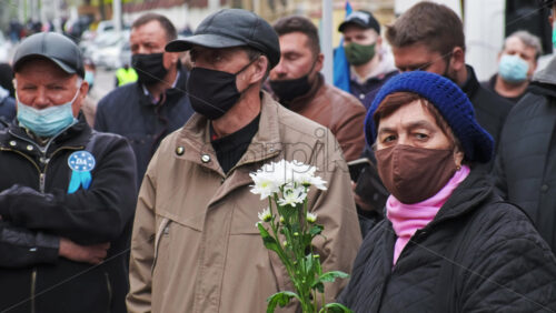 Video - CHISINAU, MOLDOVA - APRIL 28, 2021: Woman with flowers. People protesting for snap elections in front of constitutional court building