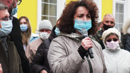 Video - CHISINAU, MOLDOVA - APRIL 28, 2021: Woman talking in the microphone. People protesting for snap elections in front of constitutional court building