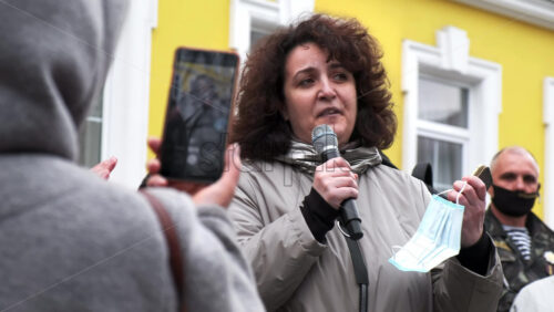 Video - CHISINAU, MOLDOVA - APRIL 28, 2021: Woman talking in the microphone. People protesting for snap elections in front of constitutional court building