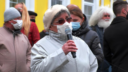 Video - CHISINAU, MOLDOVA - APRIL 28, 2021: Woman talking in the microphone. People protesting for snap elections in front of constitutional court building