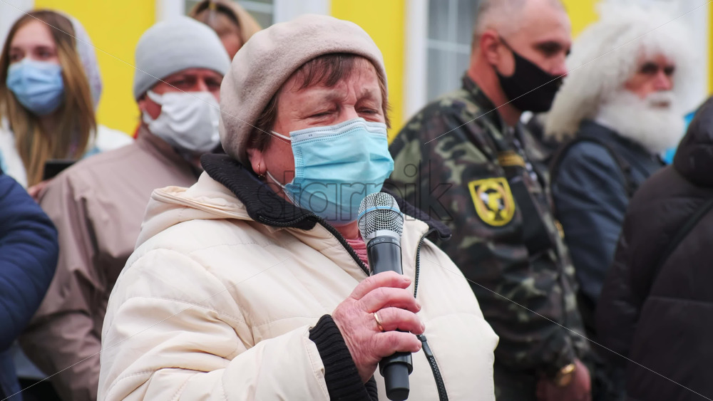 Video - CHISINAU, MOLDOVA - APRIL 28, 2021: Woman talking in the microphone. People protesting for snap elections in front of constitutional court building