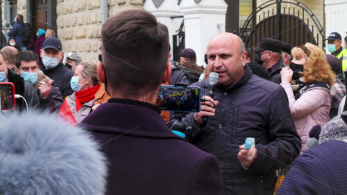 Video - CHISINAU, MOLDOVA - APRIL 28, 2021: Man talking in the microphone. People protesting for snap elections in front of constitutional court building