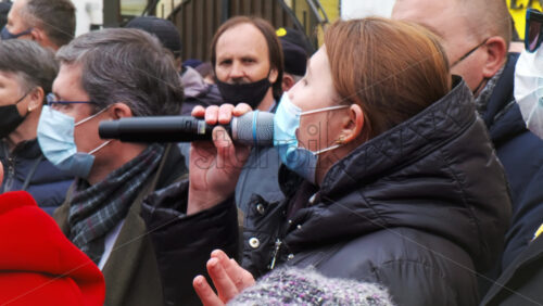 Video - CHISINAU, MOLDOVA - APRIL 28, 2021: Woman talking in the microphone. People protesting for snap elections in front of constitutional court building