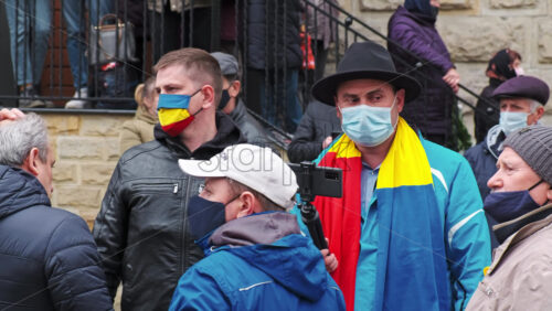 Video - CHISINAU, MOLDOVA - APRIL 28, 2021: Filming man on smartphone. People protesting for snap elections in front of constitutional court building