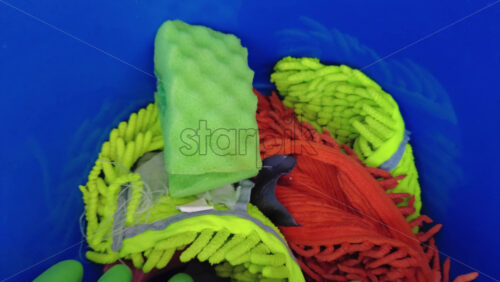 Video - Different cleaning supplies in a blue bucket