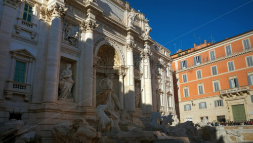 Video - Rome, Italy - February 13, 2024: The Trevi Fountain with walking tourists at sunset