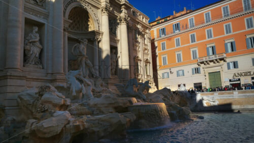 Video - Rome, Italy - February 13, 2024: The Trevi Fountain with walking tourists at sunset