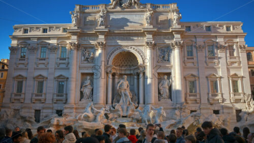 Video - Rome, Italy - February 13, 2024: The Trevi Fountain with walking tourists at sunset
