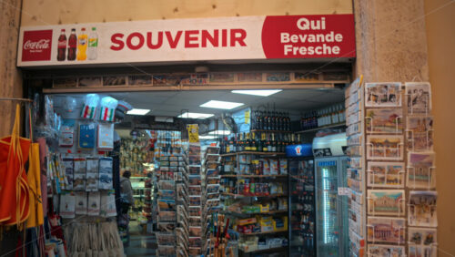 Video - Rome, Italy - February 14, 2024: Souvenir shop with postcards, keychains, and magnets