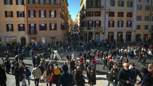 Video - Rome, Italy - February 14, 2024: Tourists walking on Spanish square near the baroque-style Fountain of the Boat in sunlight