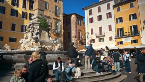 Video - Rome, Italy - February 14, 2024: Tourists resting and taking photos near the Fountain of the Pantheon at sunlight