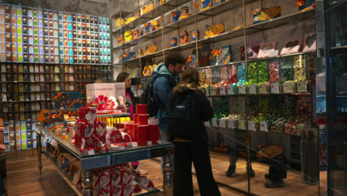 Video - Rome, Italy - February 14, 2024: People choosing sweets from the colorful shelves in Venchi shop