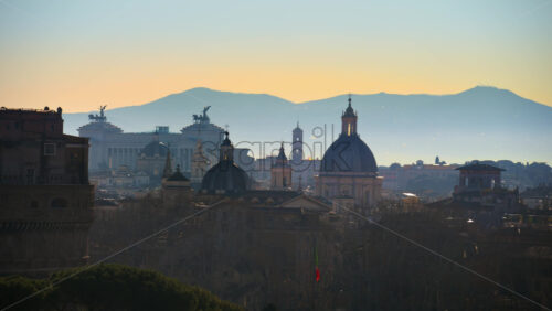 Video - Rome cityscape with mountains in background at sunset. Italy