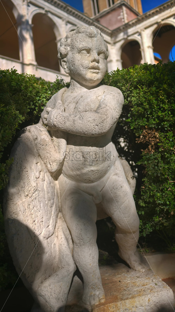 Video - A cherub in the garden of the Basilica of St Mark Evangelist at Campidoglio. Rome, Italy. Vertical