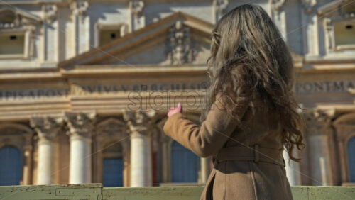 Video - Brunette, young woman in front of the St. Peter's Basilica, Vatican City, Rome, Italy