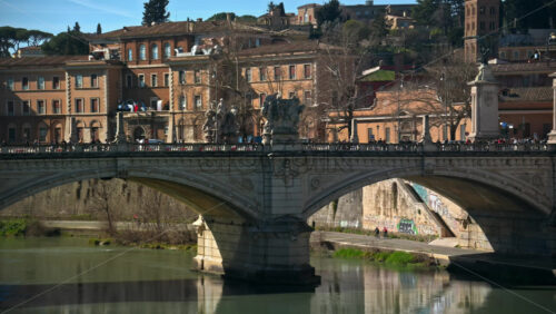 Video - Rome, Italy - February 15, 2024: Ponte Sant'Angelo across River Tiber with city view on the background