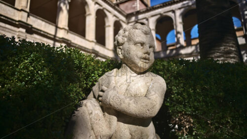 Video - A cherub in the garden of the Basilica of St Mark Evangelist at Campidoglio. Rome, Italy