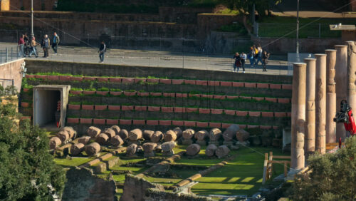Video - Rome, Italy - February 15, 2024: Ancient roman Ruins with people walking on the background, Rome, Italy