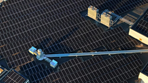 Video - Aerial drone view of solar panels at sunset. Photovoltaics on top of the roof of the building. Alternative electricity source. Concept of sustainable resources