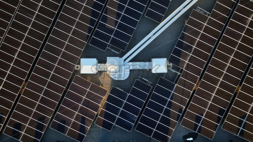 Video - Aerial drone view of solar panels at sunset. Photovoltaics on top of the roof of the building. Alternative electricity source. Concept of sustainable resources