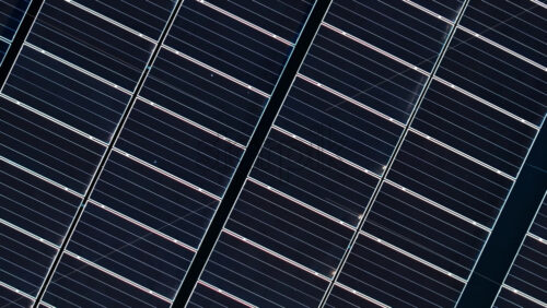 Video - Aerial drone view of solar panels. Photovoltaics on top of the roof of the building. Alternative electricity source. Concept of sustainable resources