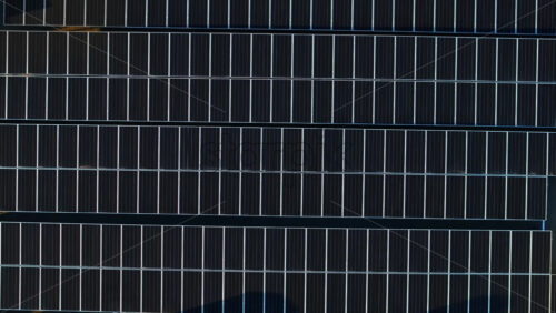 Video - Aerial drone view of solar panels at sunset. Photovoltaics on top of the roof of the building. Alternative electricity source. Concept of sustainable resources