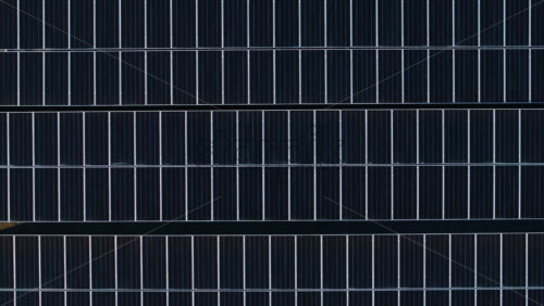 Video - Aerial drone view of solar panels at sunset. Photovoltaics on top of the roof of the building. Alternative electricity source. Concept of sustainable resources