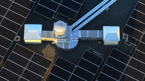 Video - Aerial drone view of solar panels at sunset. Photovoltaics on top of the roof of the building. Alternative electricity source. Concept of sustainable resources