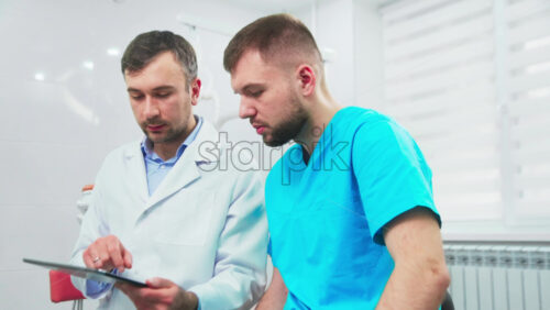Video - Doctors in the dental office talking and using tablet