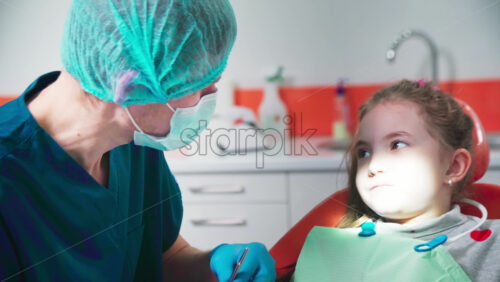 Video - Doctor in the dental office talking with kid patient at the examination