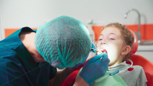 Video - Doctor in the dental office with kid patient at the examination