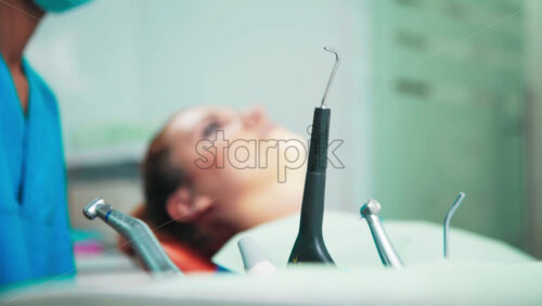 Video - Doctor using a device in the dental office with patient at the examination