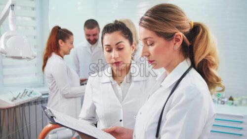Video - Doctors in the dental office. Talking nurses and one noting doctor
