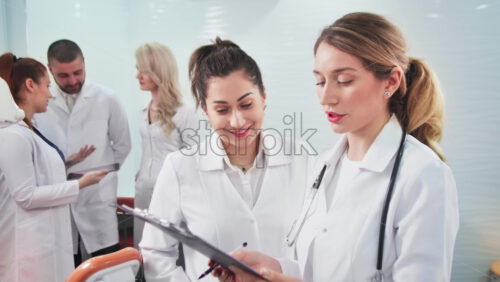 Video - Doctors in the dental office. Talking nurses and one noting doctor