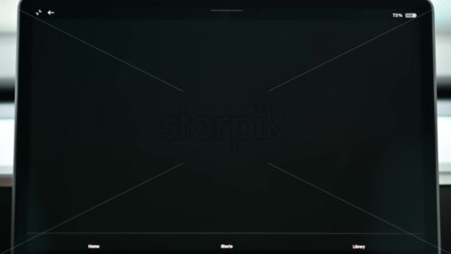 Video - Chisinau, Moldova - January 23, 2024: Male hand opening YouTube application on the red Tesla Model 3 electric car. Light theme