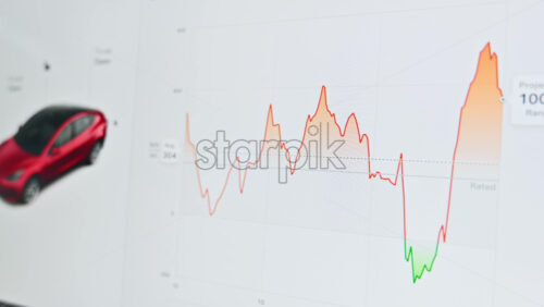 Video - Chisinau, Moldova - January 23, 2024: Tesla Model 3 energy consumption graph on the touch screen inside the red electric car. Light theme