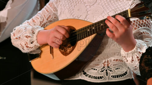 Video - Close-up of a woman playing the mandolin