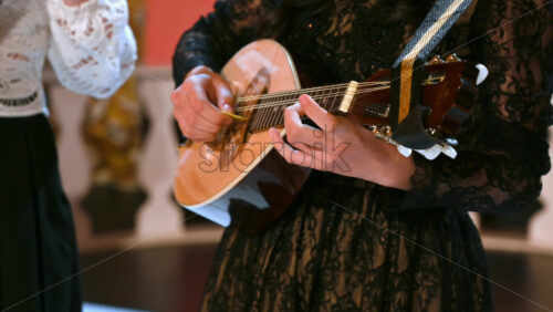 Video - Close-up of two women playing the mandolin